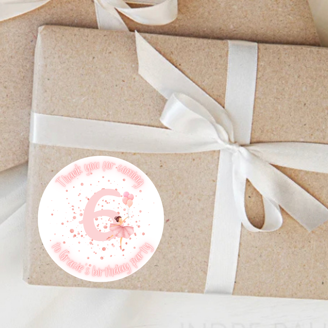 Gift wrapped in brown paper with a white ribbon and a Personalised pink ballerina sticker on a light background