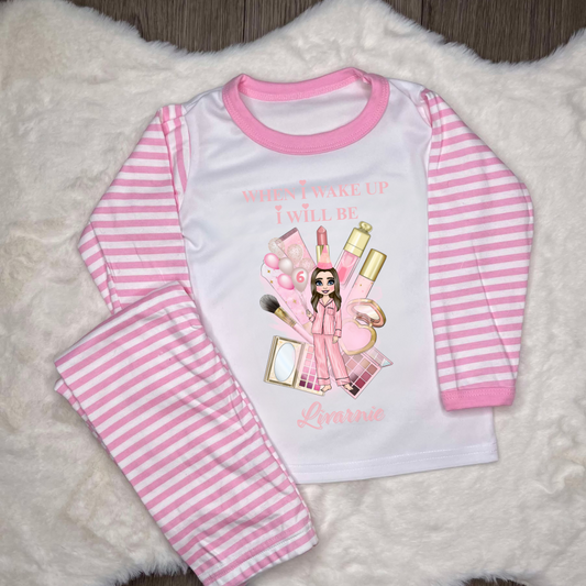 Pink striped pyjamas with image of plousie doll and make up with personalised text