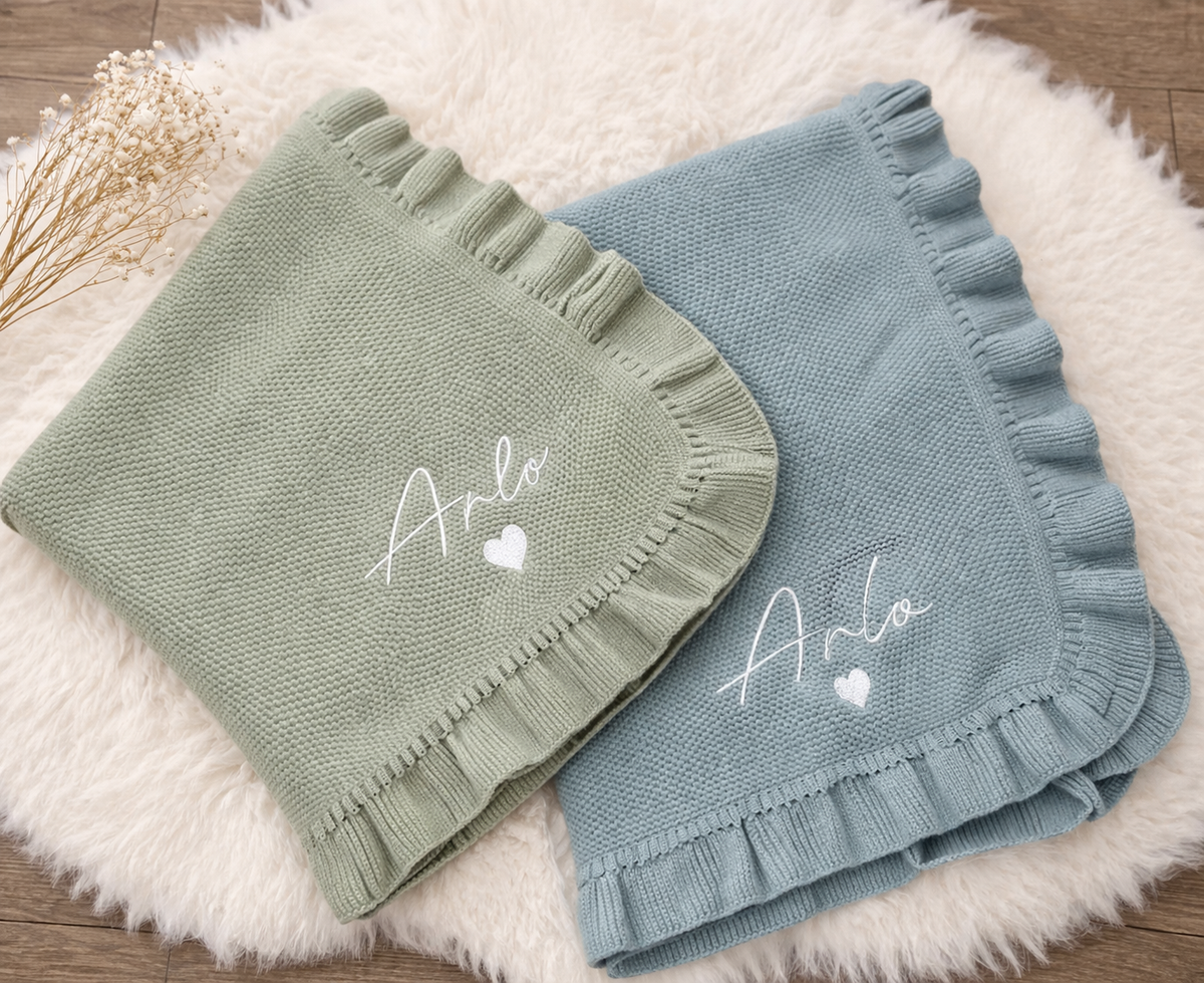 Frilly knitted baby blanket embroidered with a personalised name