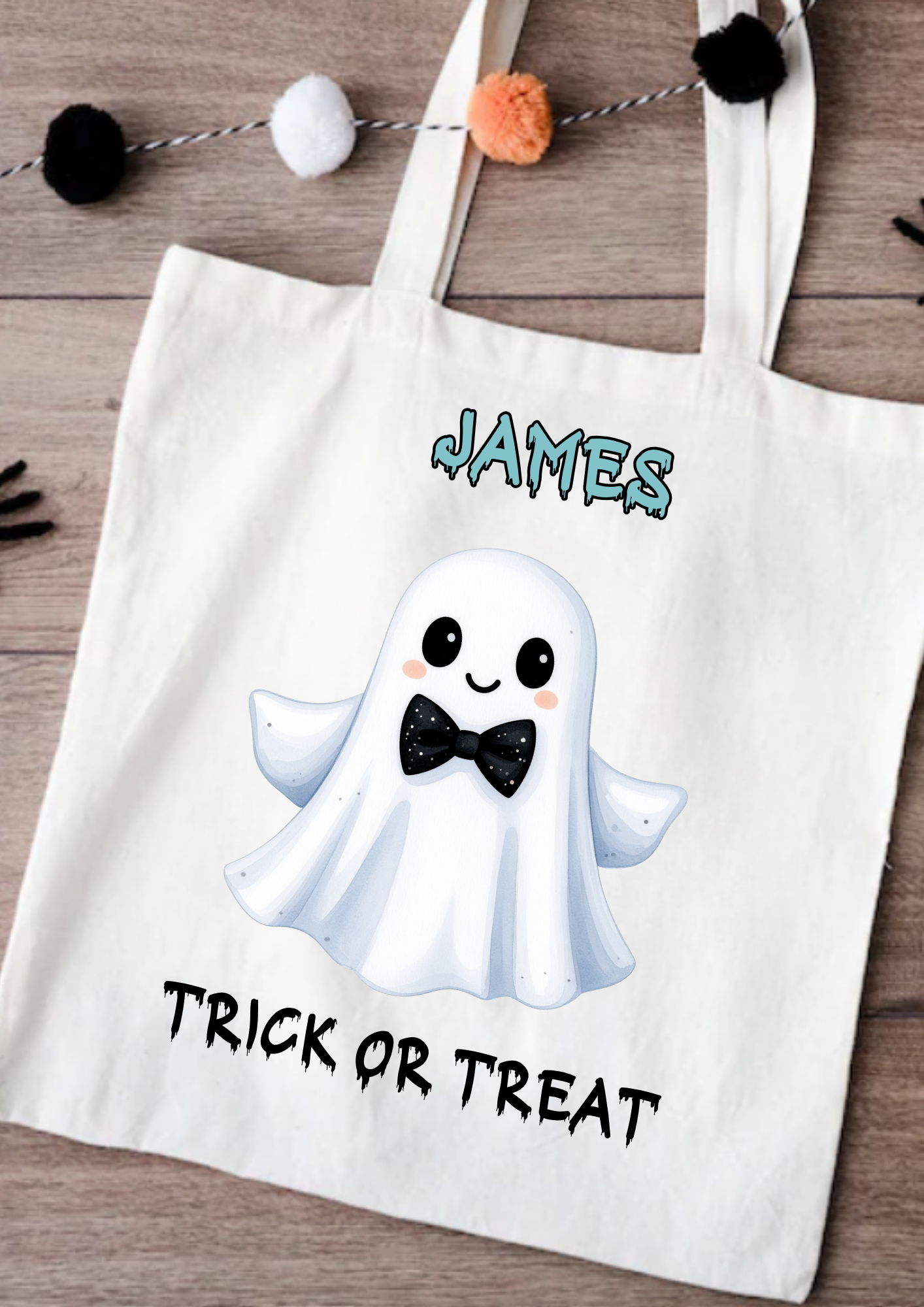 Tote bag with a ghost design and 'Trick or Treat' text on a wooden surface.