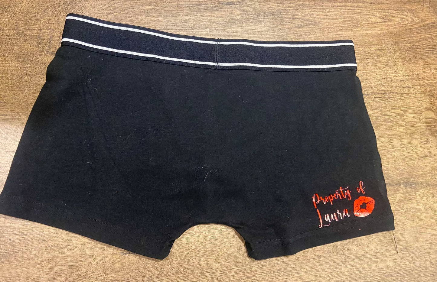 Black men's boxers with the words property of Laura in red