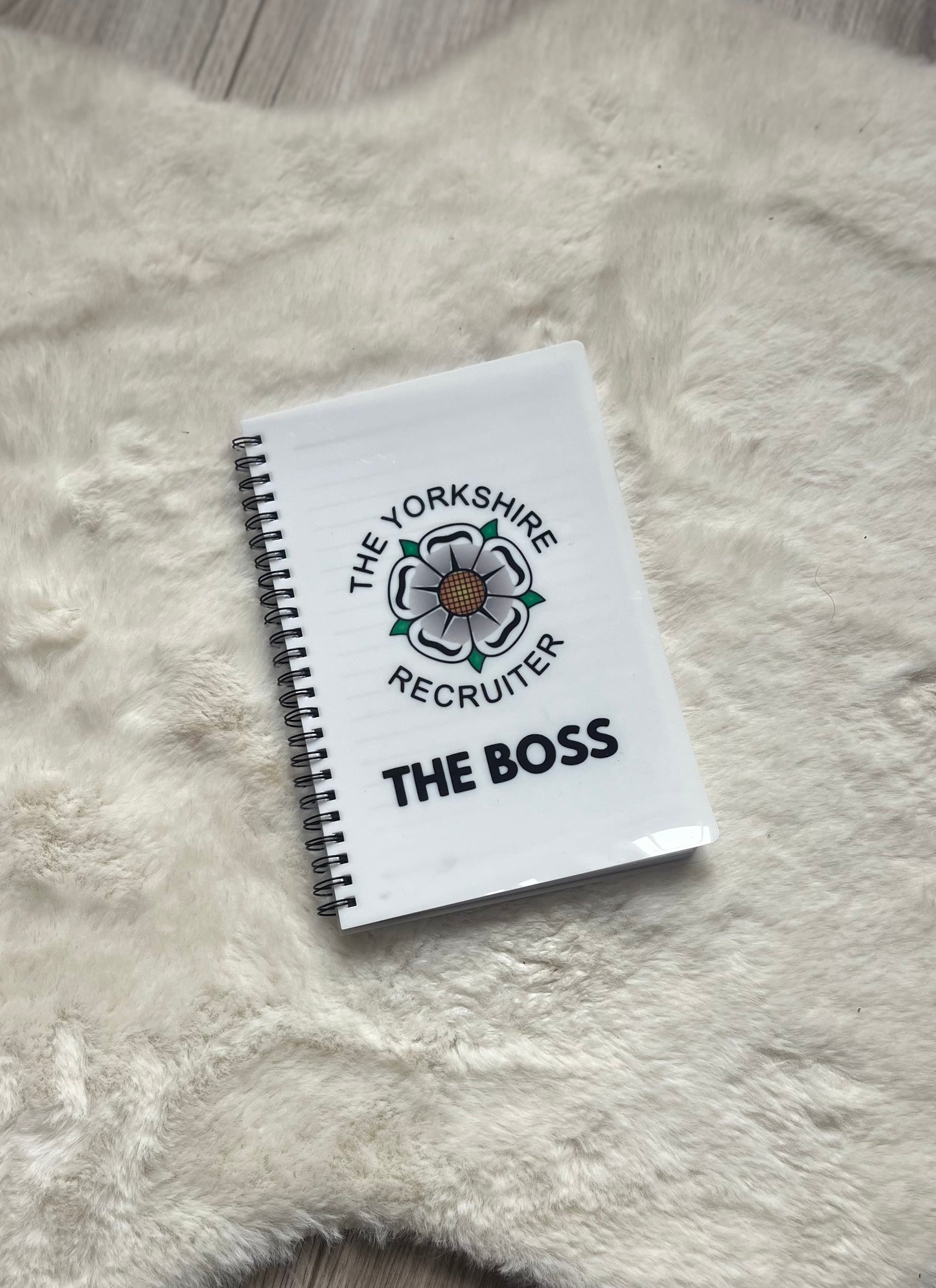 Notebook with 'The Yorkshire Recruiter' logo and text on a fluffy white surface
