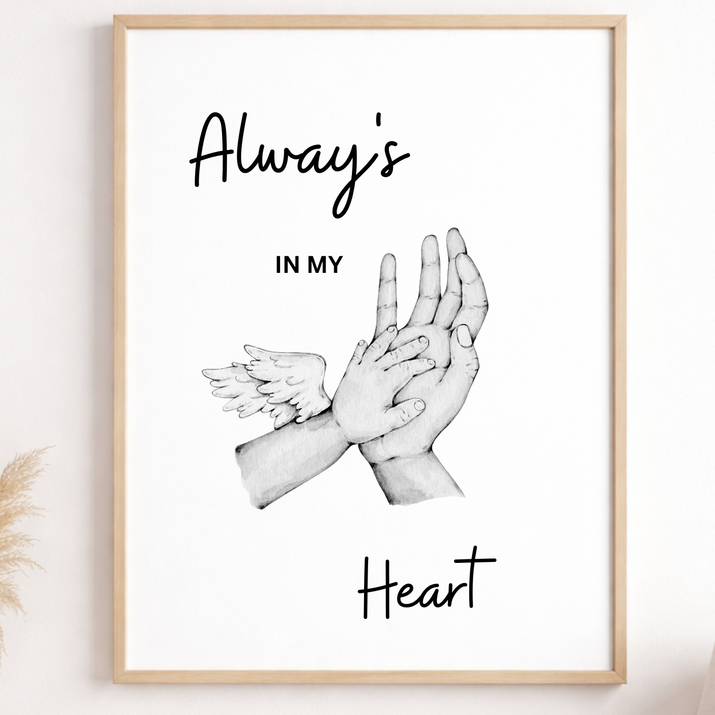 Framed artwork with hands holding a heart and text 'Always in my heart' on a wall.