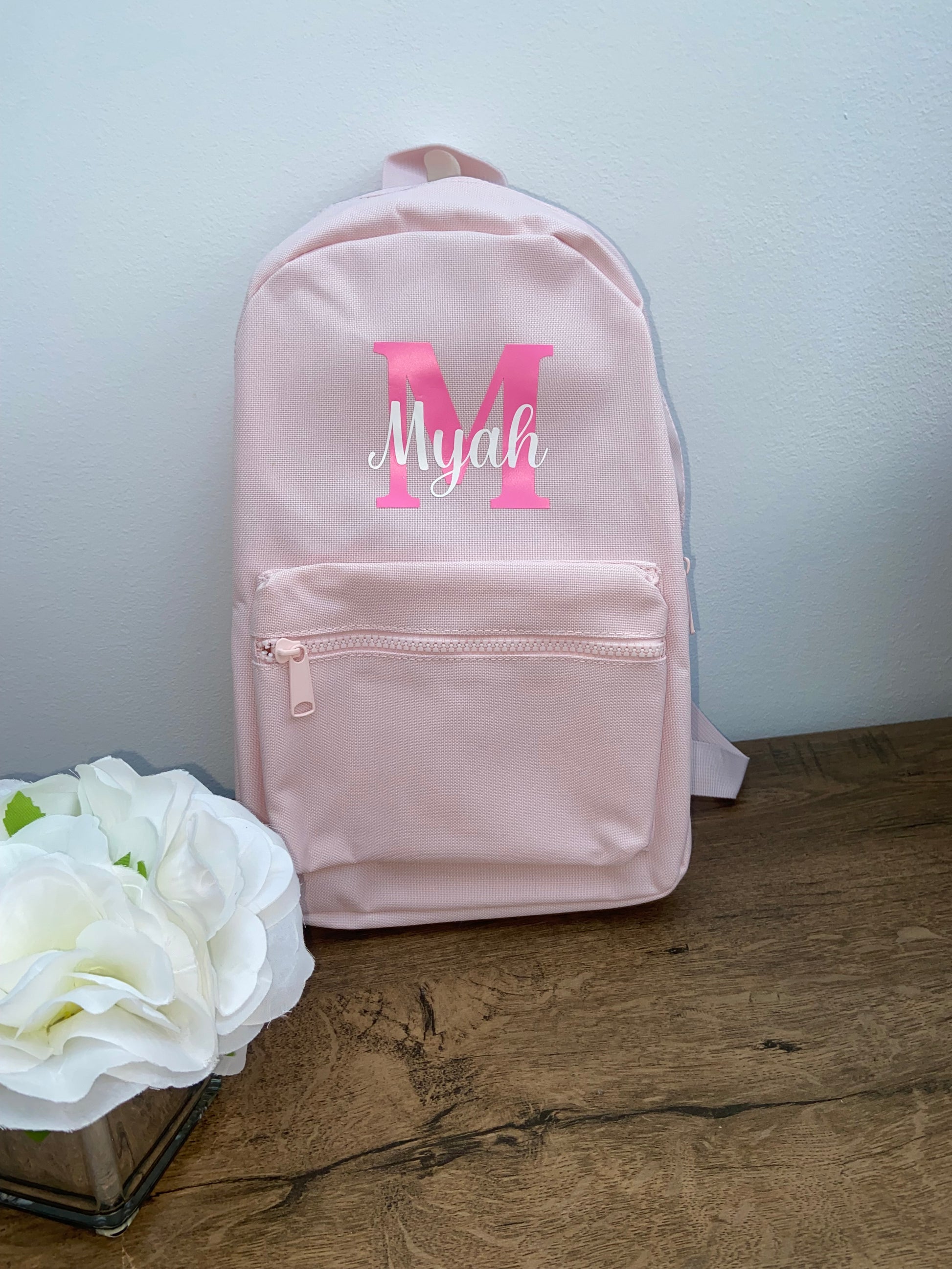 Personalised Light Pink backpack with neon pink letter and white name text