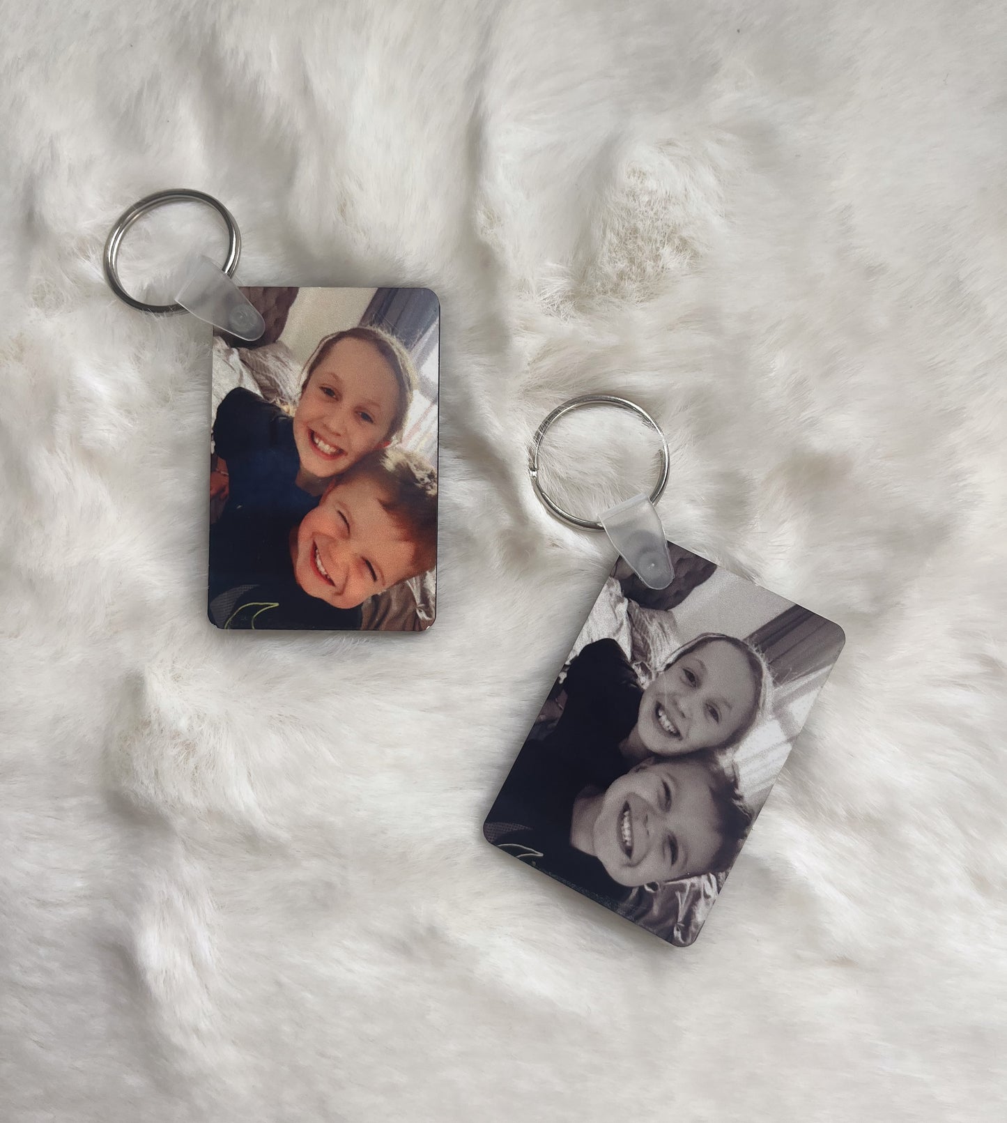 2 rectangle photo keyrings that have personalised images on.