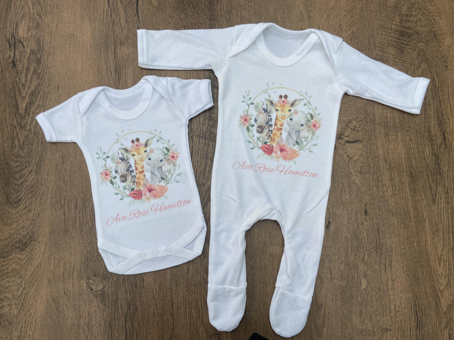 White baby vest and sleepsuit with safari design