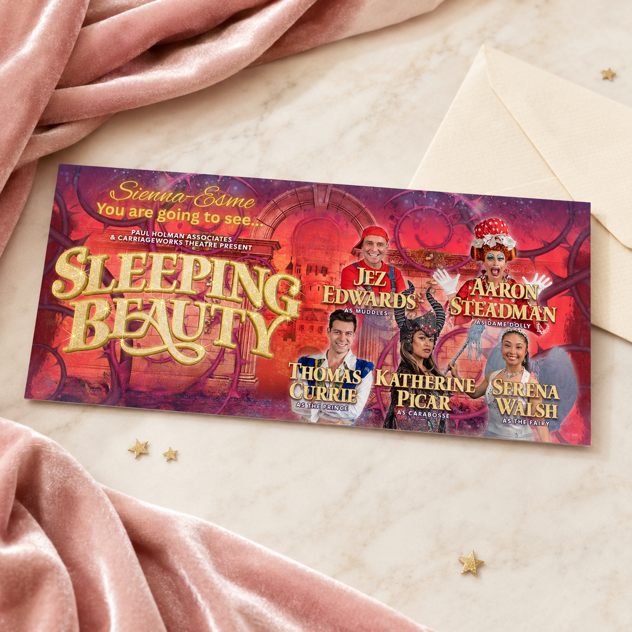 Personalised Sleeping Beauty theatre show surprise ticket displayed on a pink velvet and marble background.