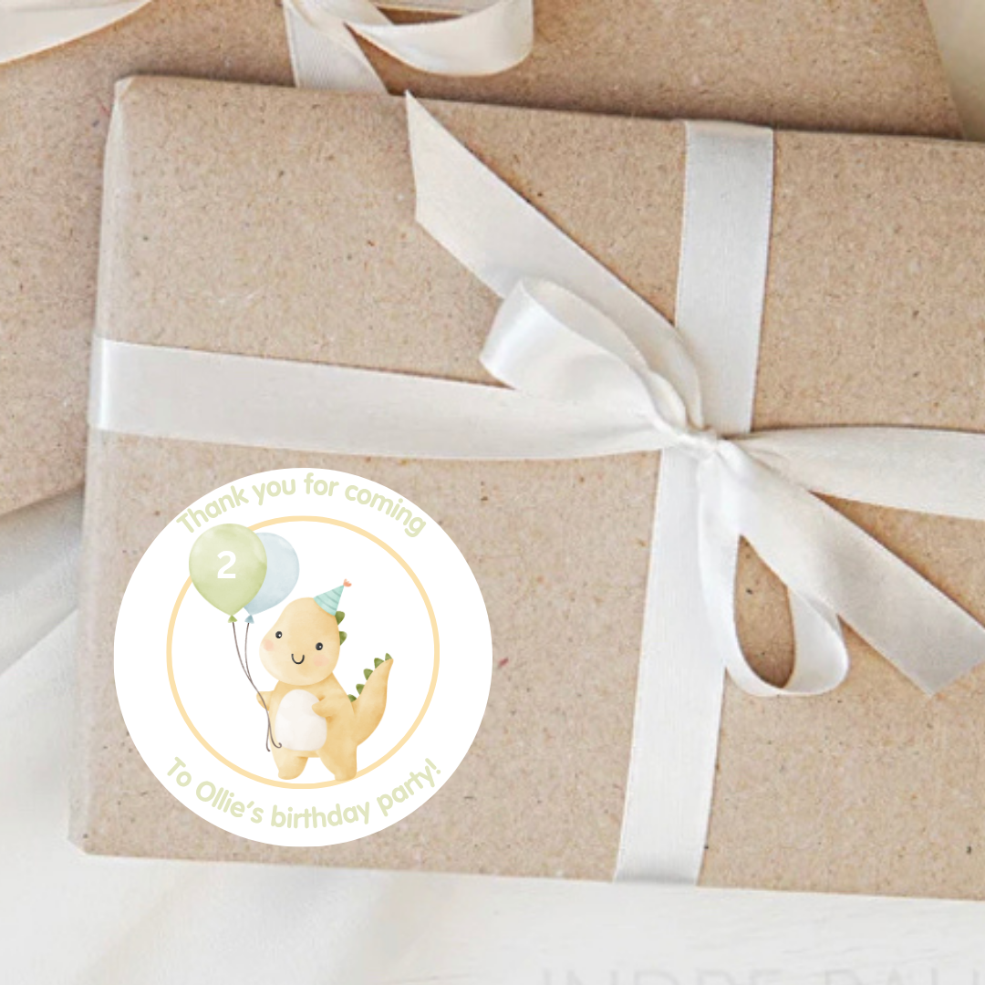 Gift box wrapped in brown paper with a white ribbon and a dinosaur-themed sticker.