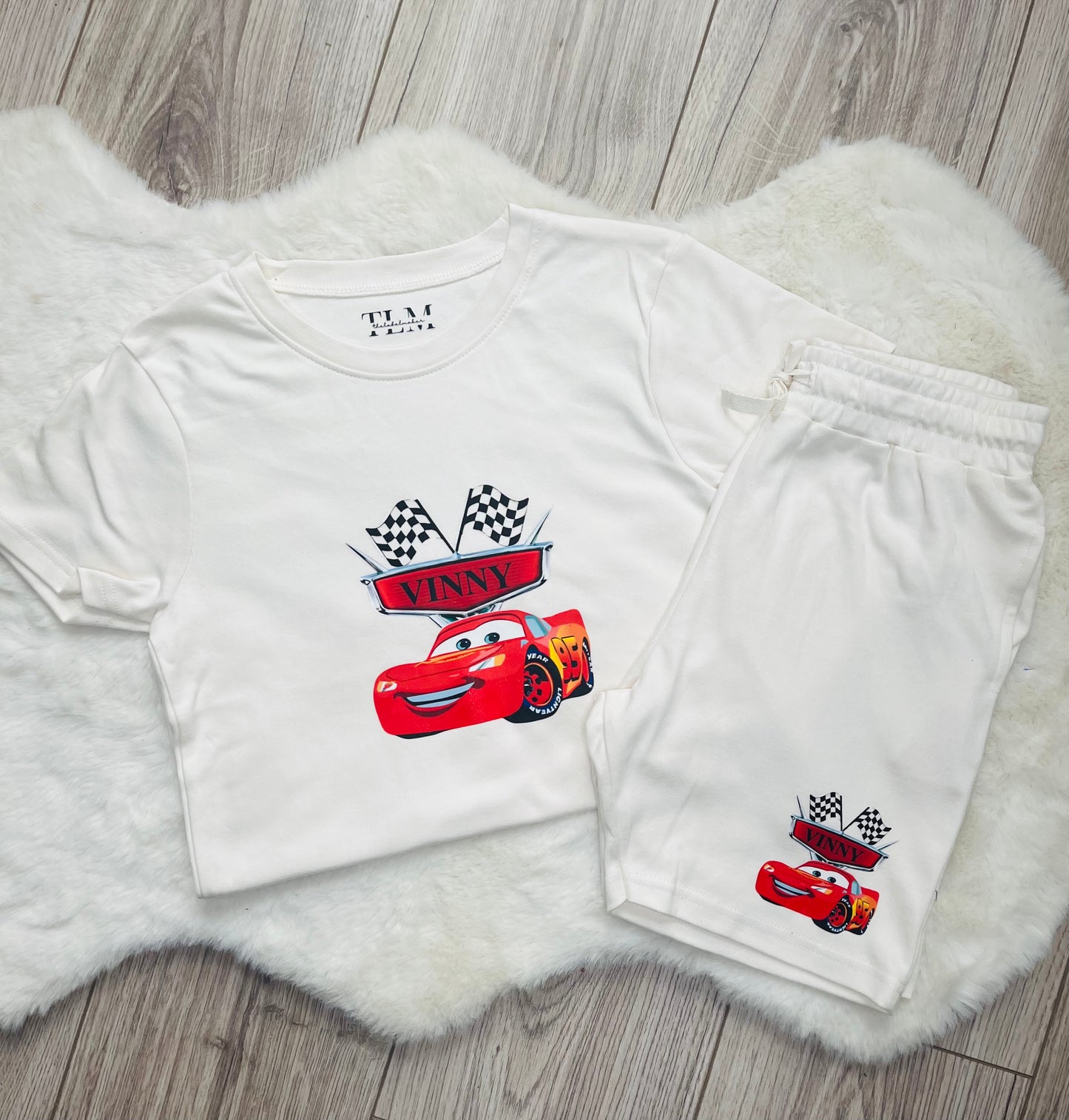 Personalised kids summer outfit photographed on white rug with neutral flooring background
