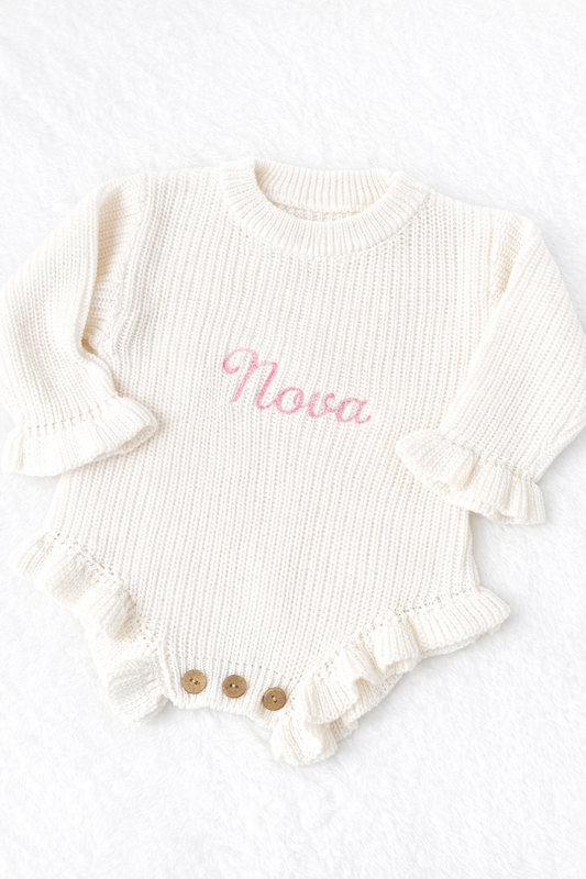 White ribbed baby romper with 'Nova' embroidery on a white background