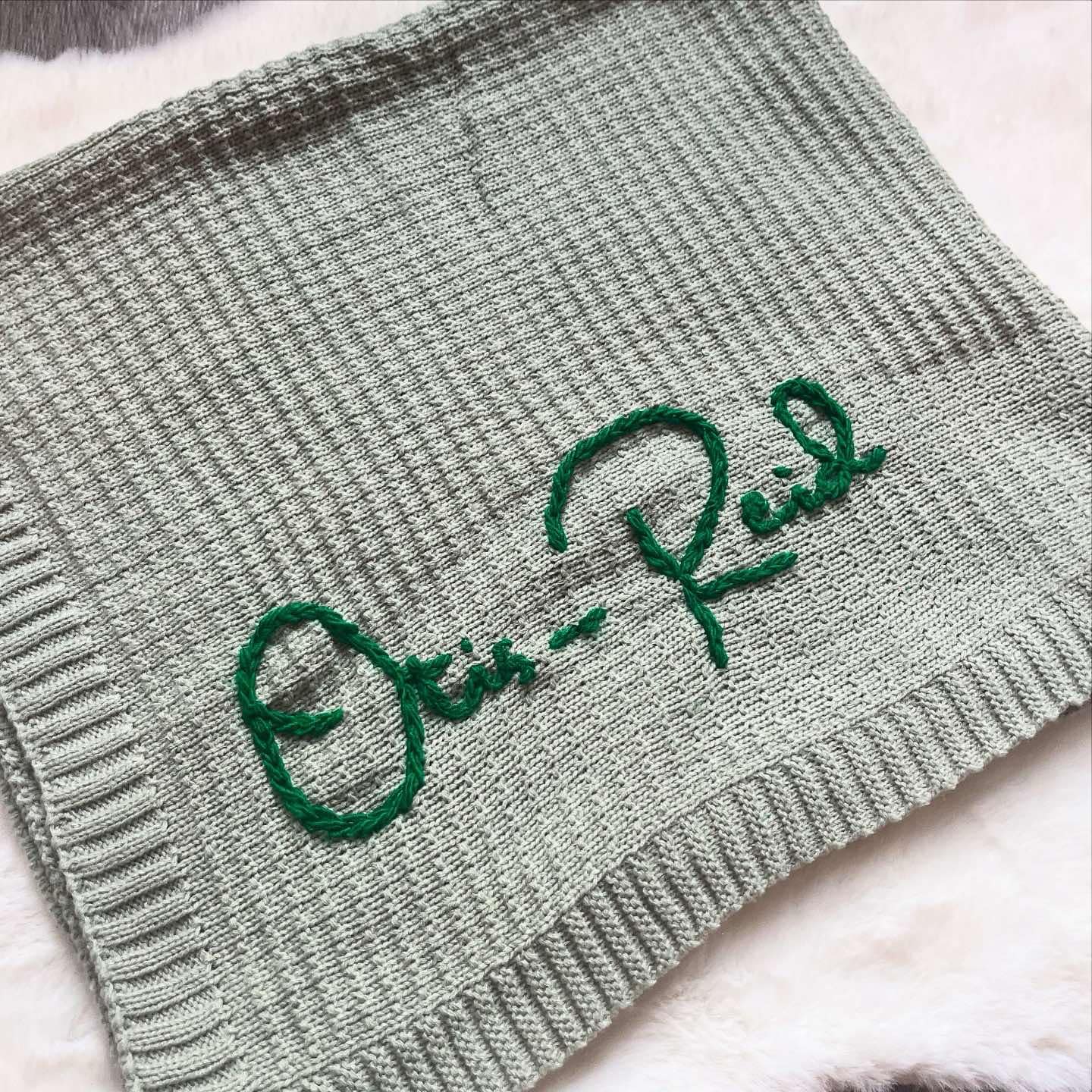 Sage green personalised knitted baby blanket with embroidered name "Otis-Reid"