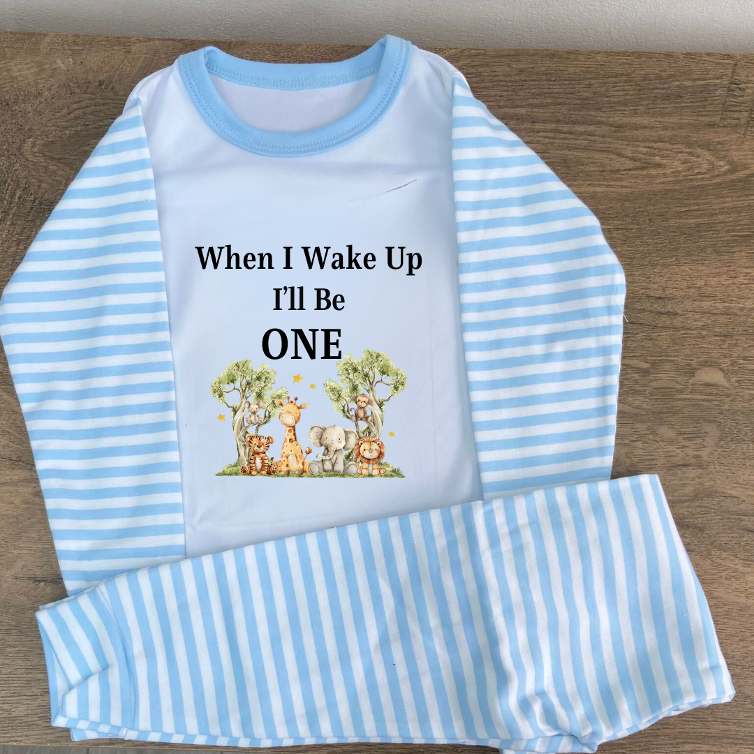Blue striped pyjamas with the words when i wake up ill be one in black with an image of two trees and safari ANIMALS