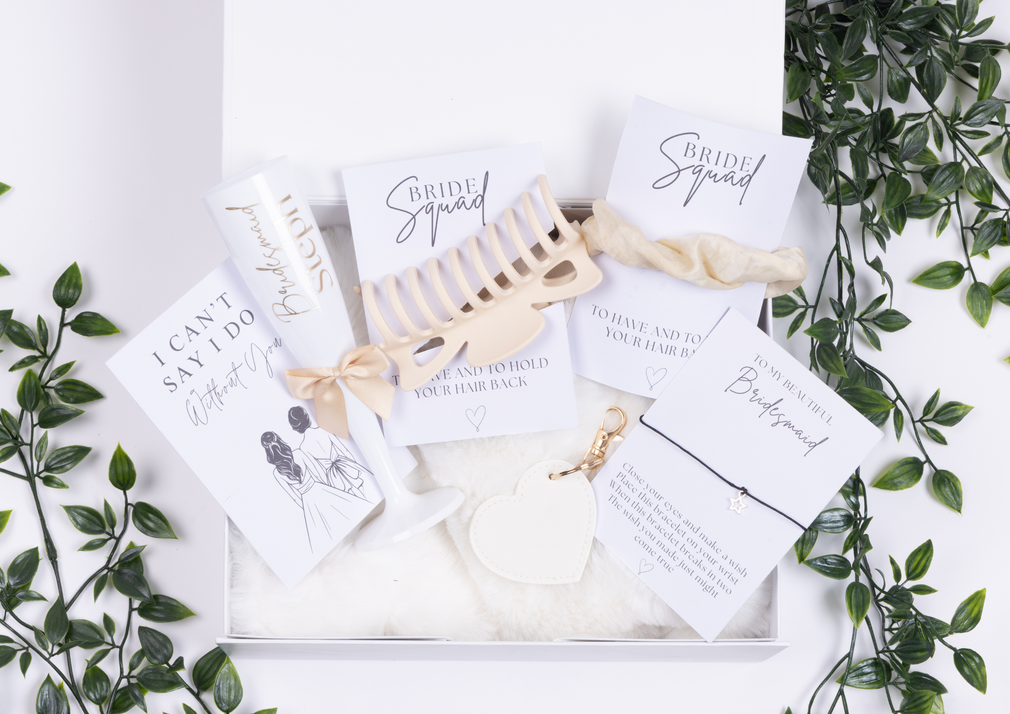 White magnetic gift box, white champagne flute ,wish bracelet , white cards with black and gold text 