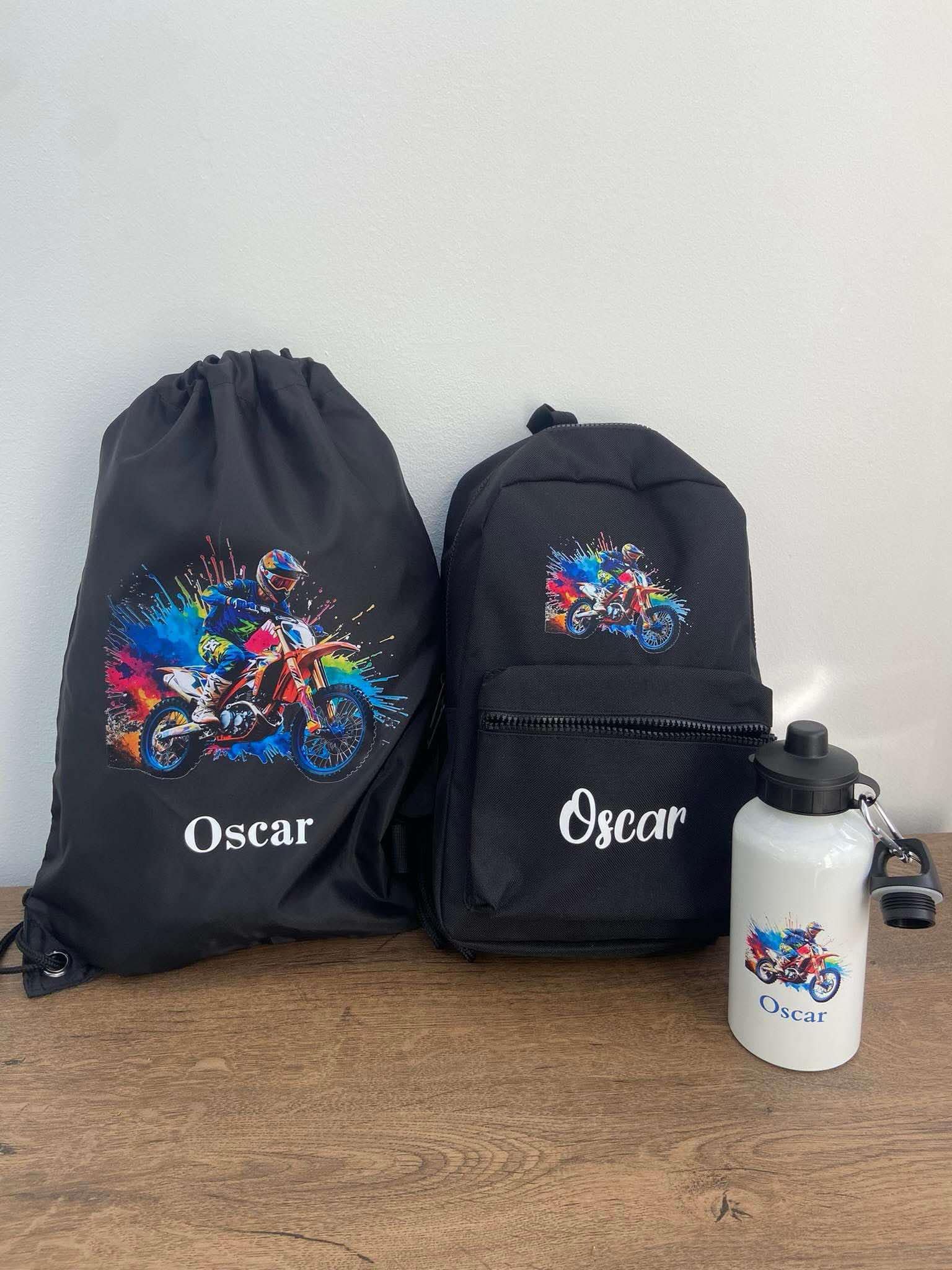 Black backpack, drawstring bag, and water bottle with 'Oscar' branding on a wooden surface.