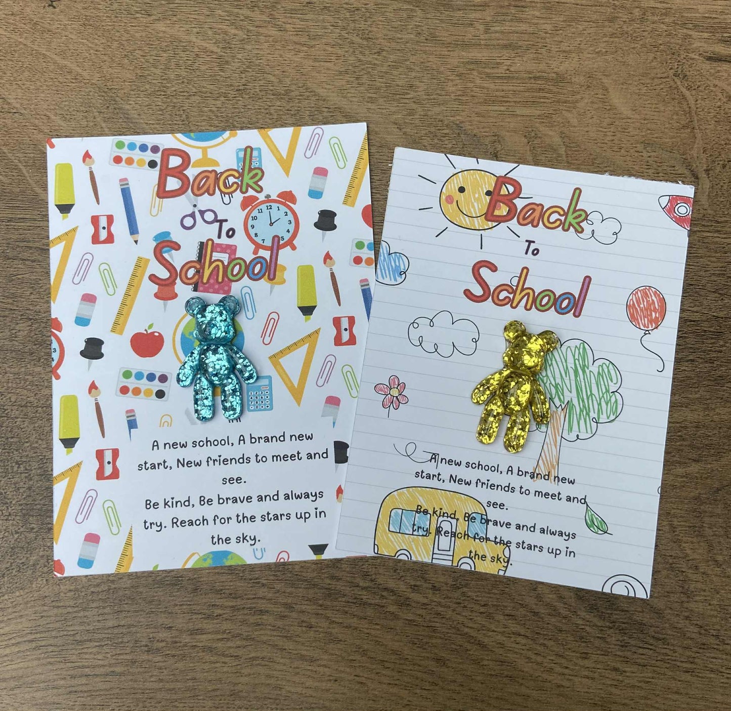 Two 'Back to School' themed cards with colorful illustrations on a wooden surface.