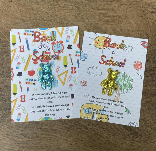 Two 'Back to School' themed cards with colorful illustrations on a wooden surface.