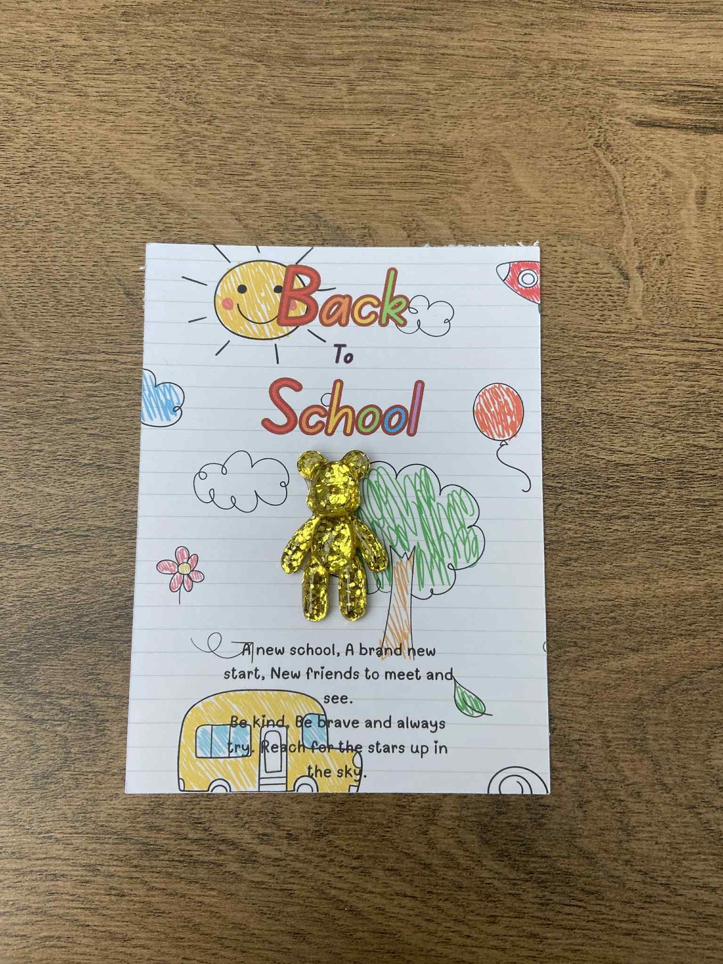 Card with 'Back to School' text and illustrations on a wooden surface