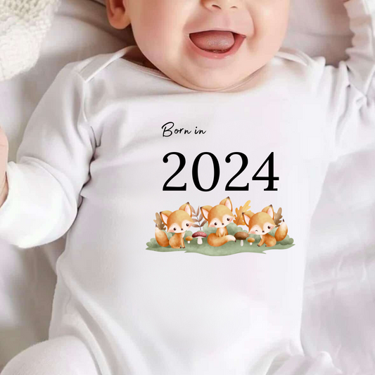 white baby vest with fox  image and text saying born in 2024, can be personalised