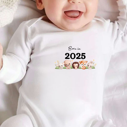 white baby sleepsuit with  animals image and text saying born in 2025, can be personalised