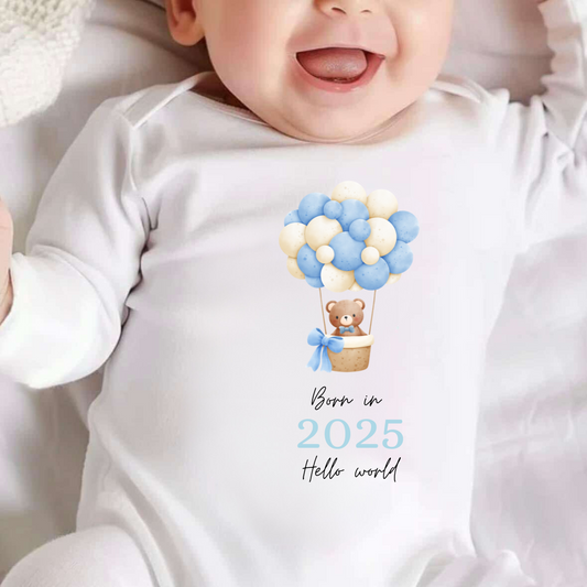 white baby vest with hot air balloon bear image and text saying born in 2025, can be personalised