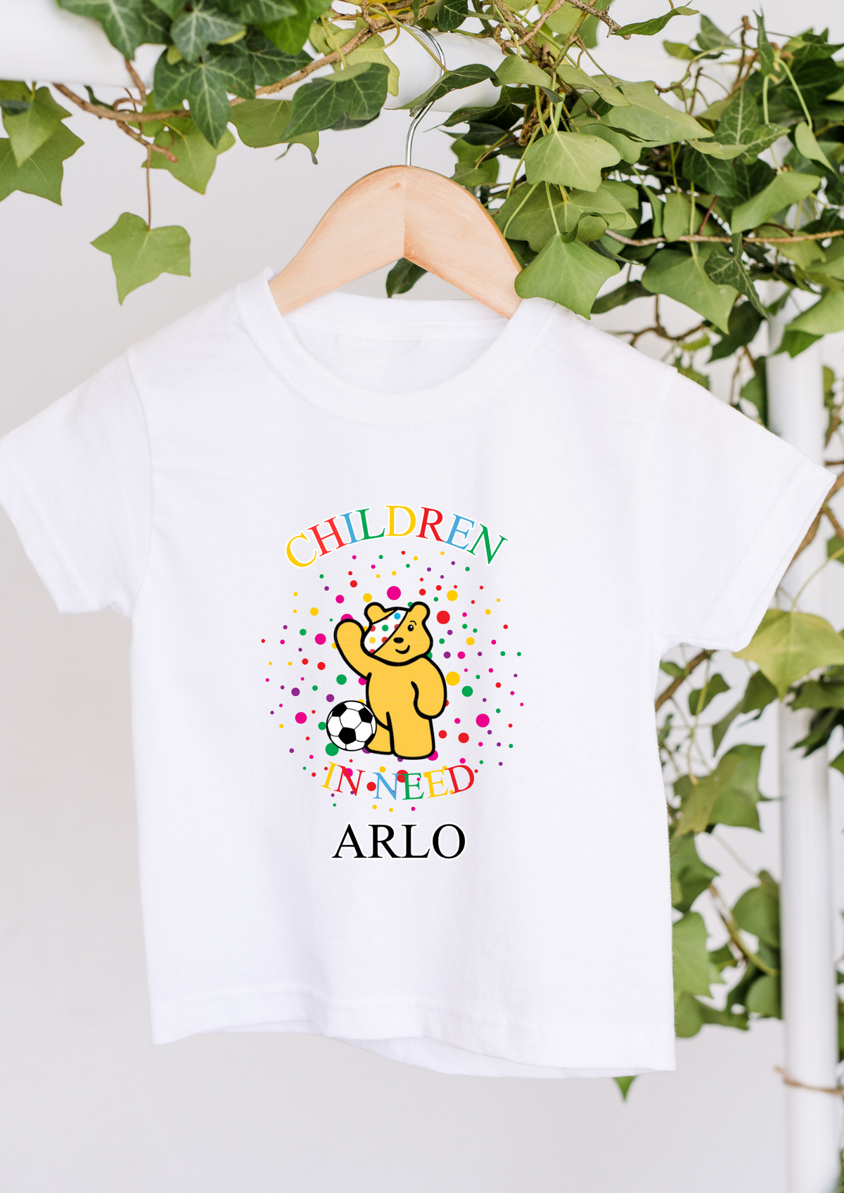 White personalised Children in Need T-shirt with Pudsey Bear, football, colourful spots and name Arlo