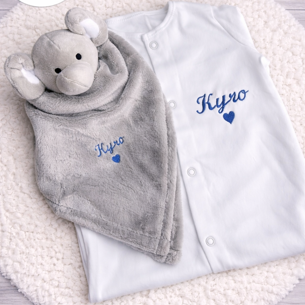 white baby sleepsuit and baby comforter with name embroidered 