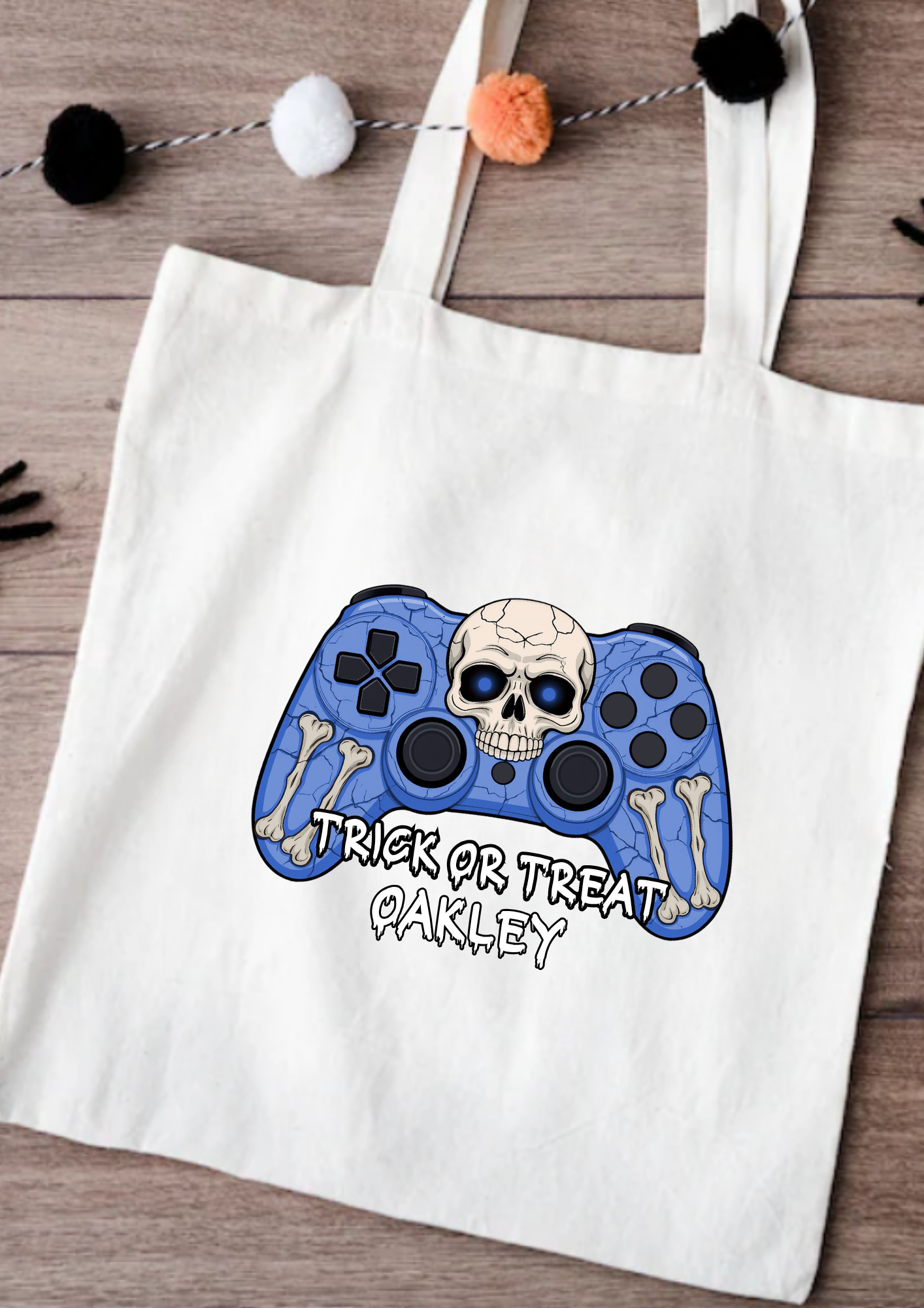 Tote bag with a Halloween-themed controller design on a wooden surface