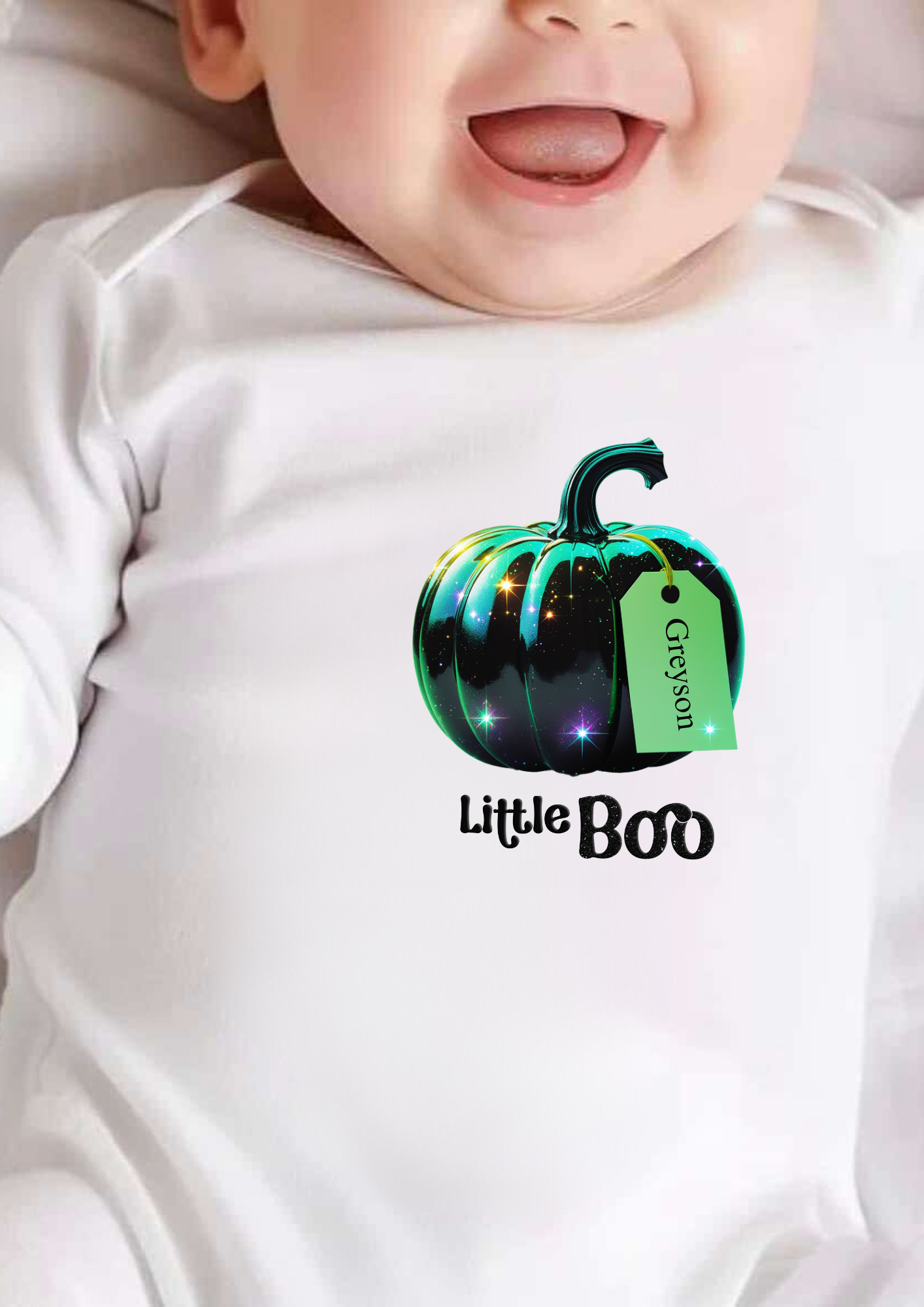 Baby wearing a onesie with a colorful pumpkin design and text.