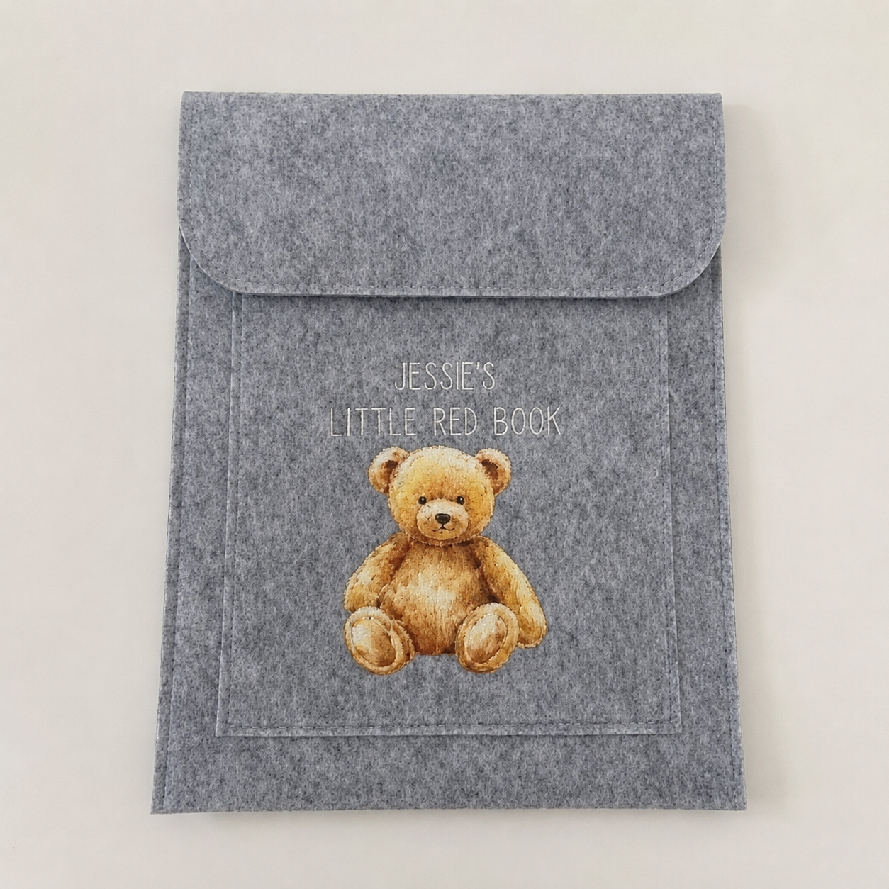 Grey personalised Little Red Book cover featuring the name Jessie and a teddy bear design.