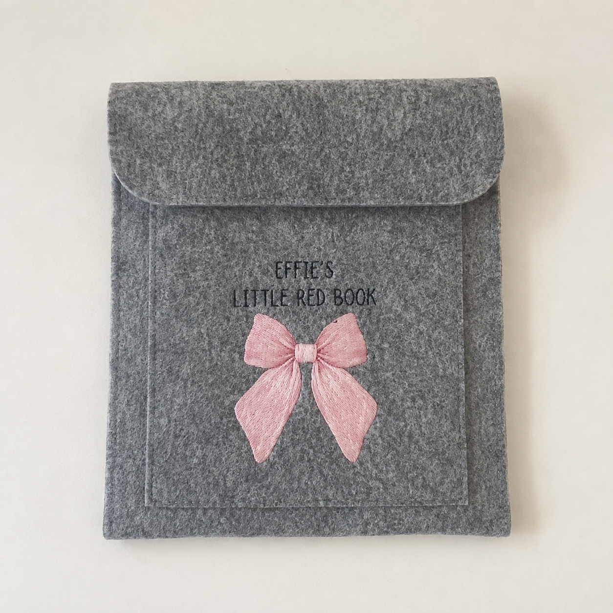 Grey personalised baby red book cover featuring the name Effie and a pink bow design.