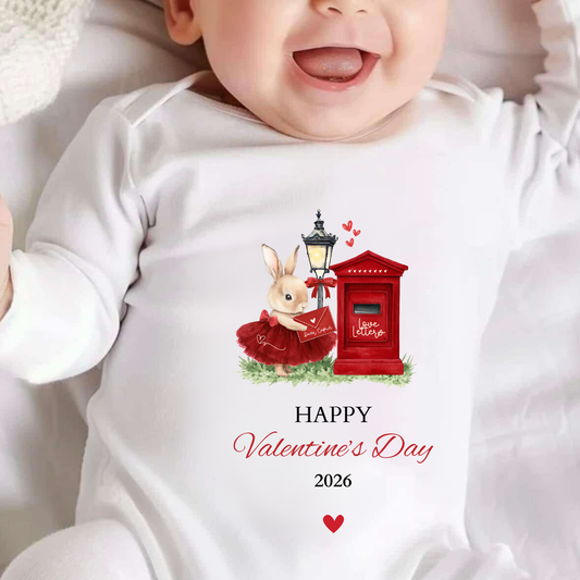 Baby wearing a onesie with a Valentine's Day design featuring a rabbit and red mailbox.