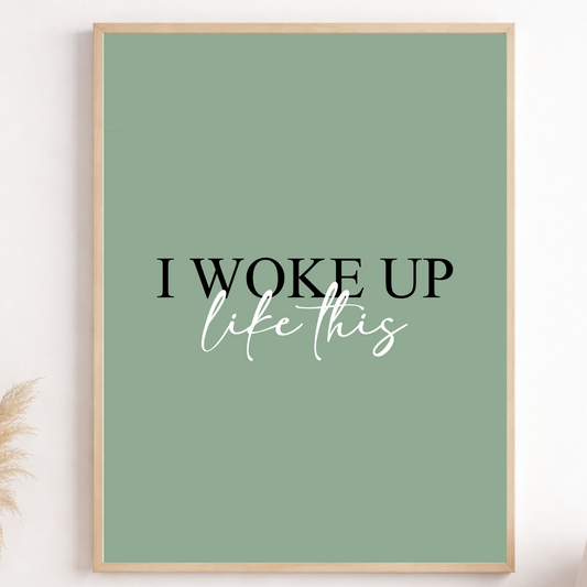 Framed poster with 'I woke up like this' text on a green background, displayed in a room.