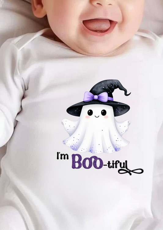 Baby wearing a Halloween-themed onesie with a ghost and text.