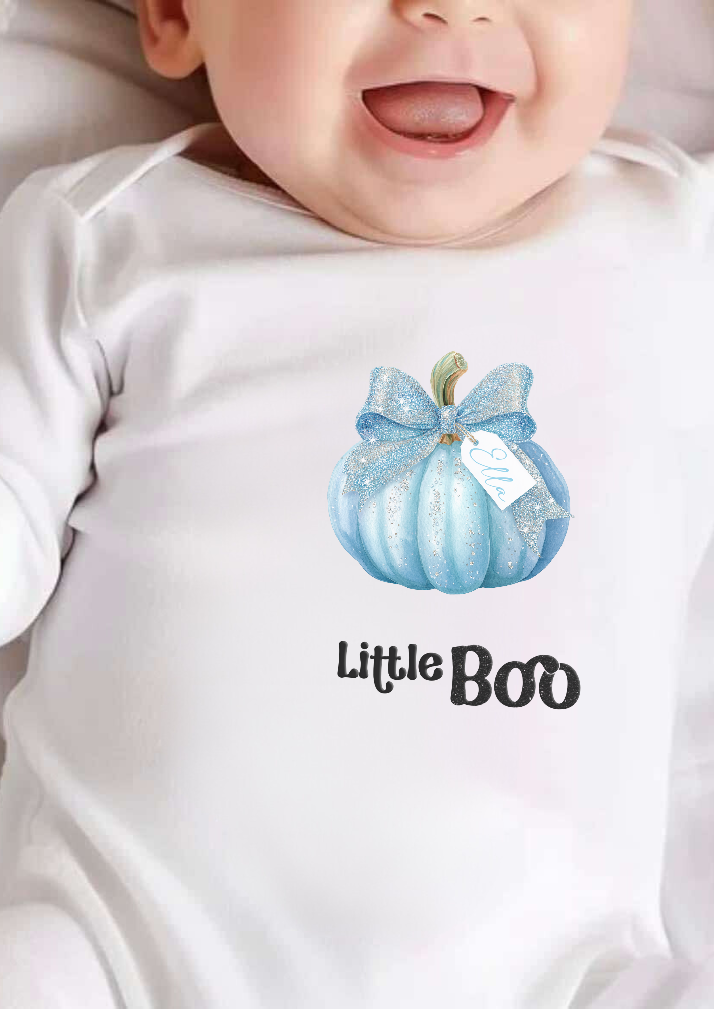Baby wearing a onesie with a blue pumpkin and 'Little Boo' text