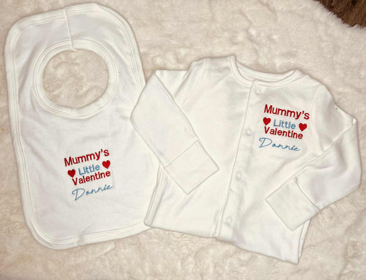 White bib and long-sleeve shirt with personalized text on a light background