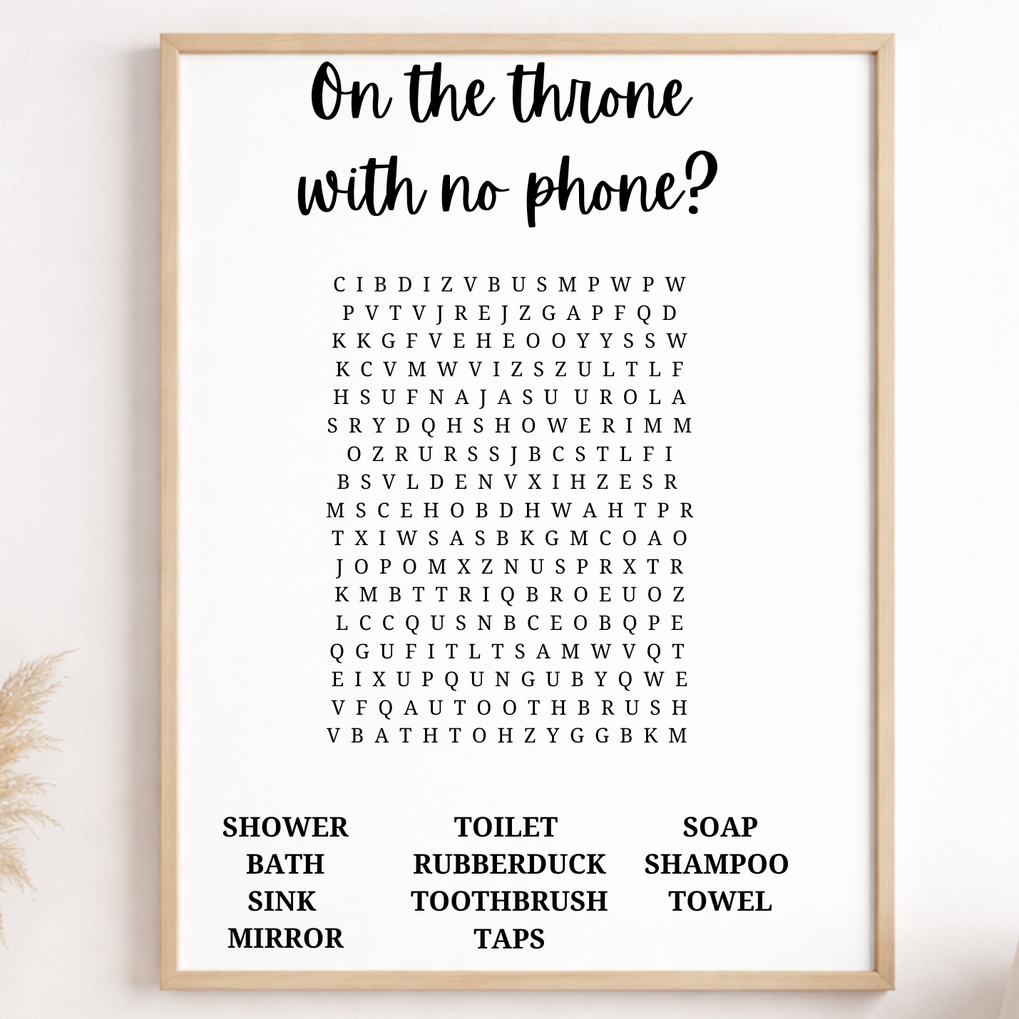 Framed bathroom wall art with text and alphabet design on a white wall.
