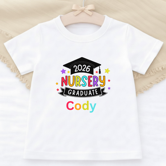 White t-shirt with '2026 Nursery Graduate Cody' design on a beige background