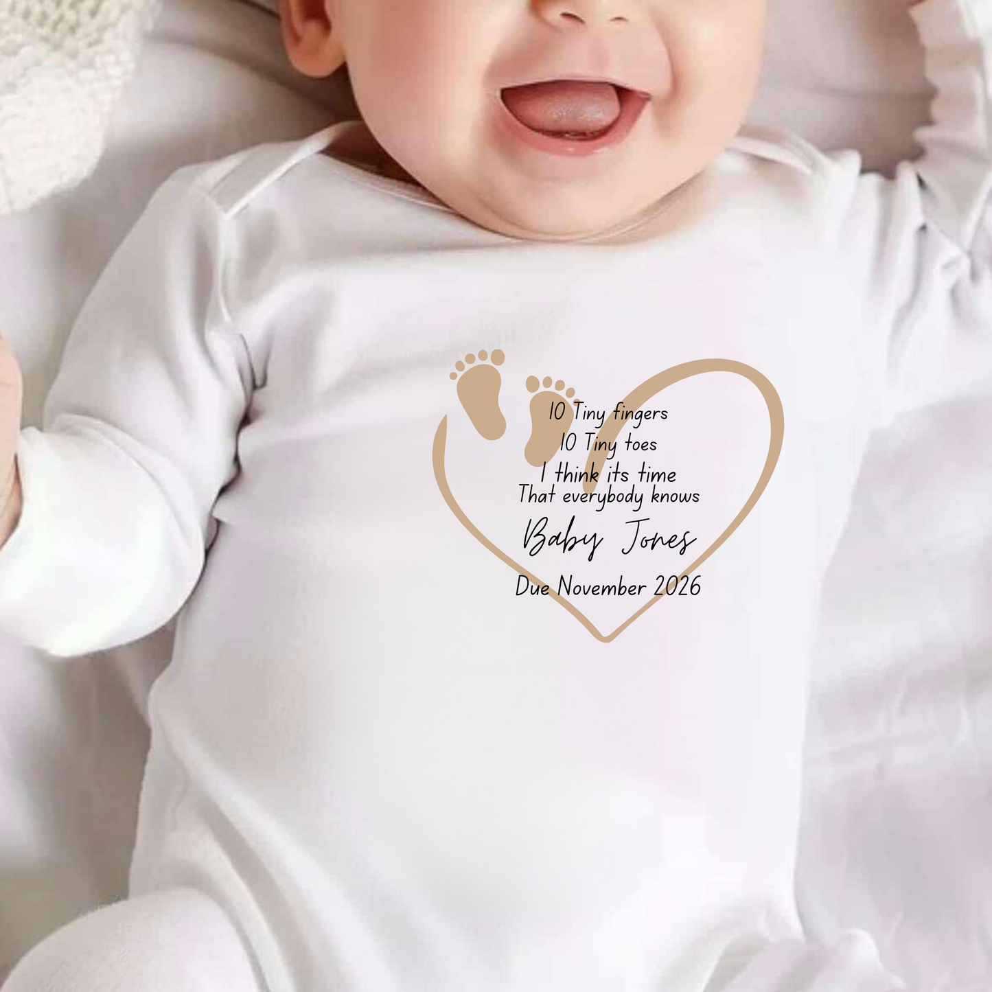 Baby wearing a white onesie with personalized text and design