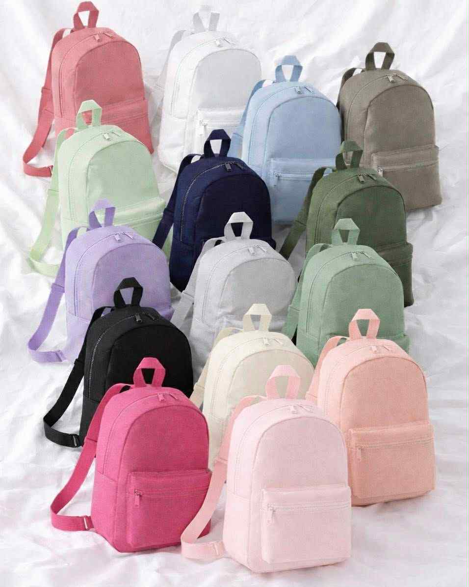 Collection of colorful backpacks on a light background