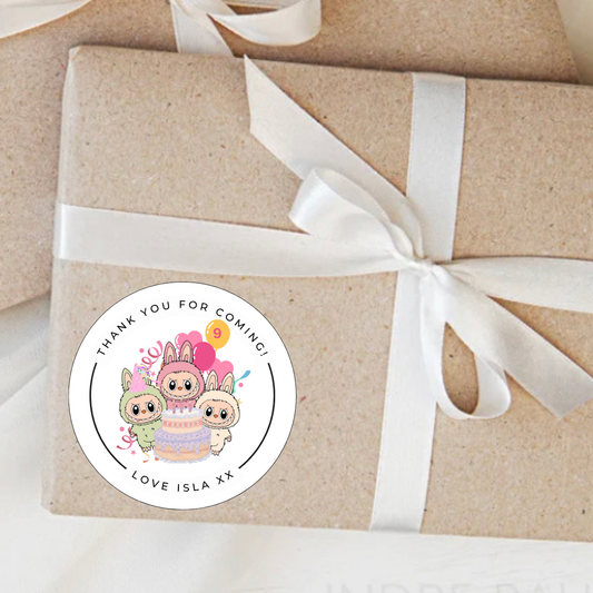 Gift wrapped in brown paper with a white ribbon and a personalised sticker on a light background
