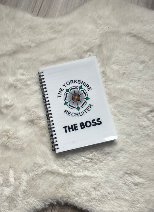 Notebook with 'The Yorkshire Recruiter' logo and text on a fluffy white surface