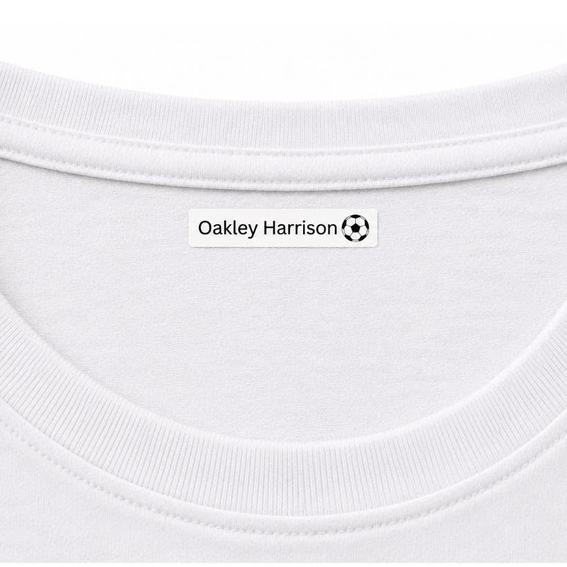 Close-up of a white crew-neck t-shirt showing the inner neck label with the text 'Oakley Harrison' and a small soccer ball logo.