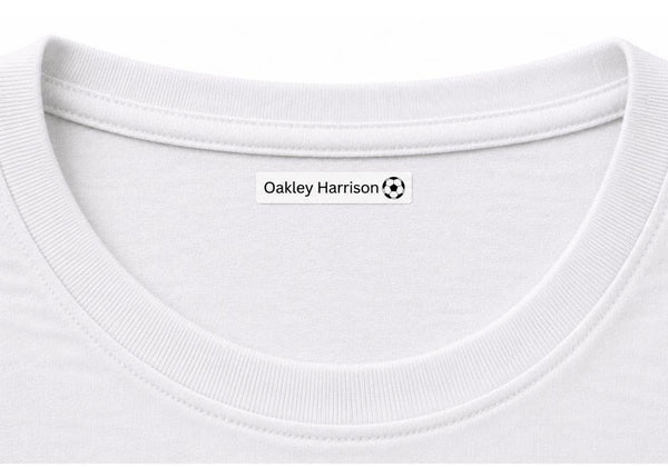 Close-up of a white crew-neck t-shirt showing the inner neck label with the text 'Oakley Harrison' and a small soccer ball logo.
