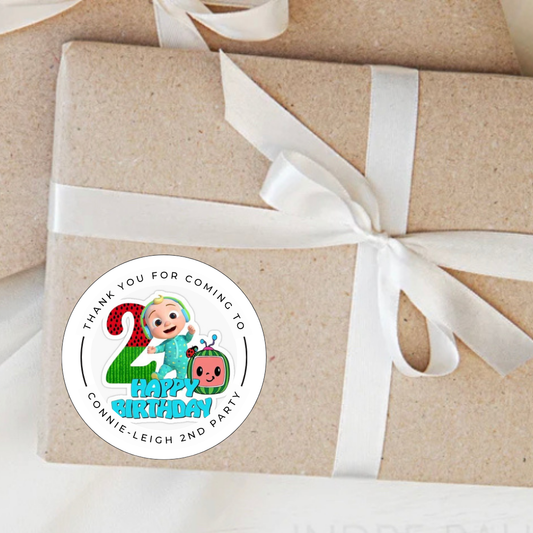 Gift wrapped in brown paper with a white ribbon and a personalized birthday sticker.