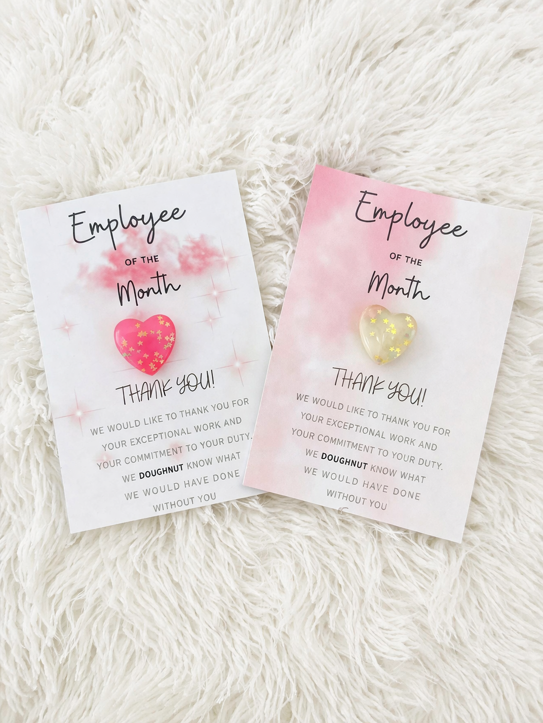 Two 'Employee of the Month' appreciation cards on a fluffy white surface