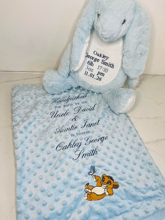 Baby blanket and soft toy with personalized text on a light background