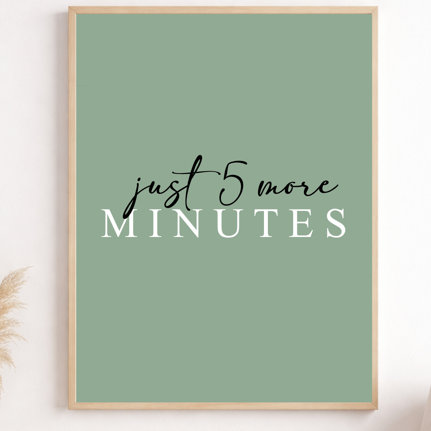 Framed poster with 'just 5 more minutes' text on a green background, displayed in a room.
