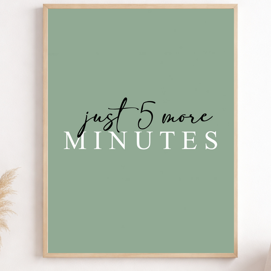 Framed poster with 'just 5 more minutes' text on a green background, displayed in a room.