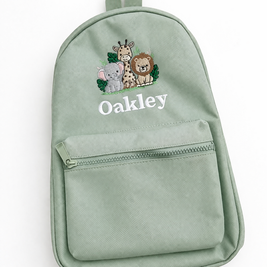 Green backpack with animal illustrations and 'Oakley' text on a white background