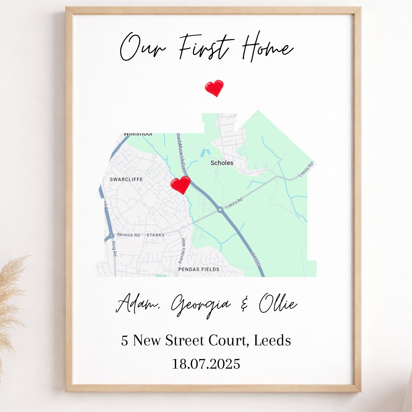 Framed map print with 'Our First Home' text and personalized details on a wall.